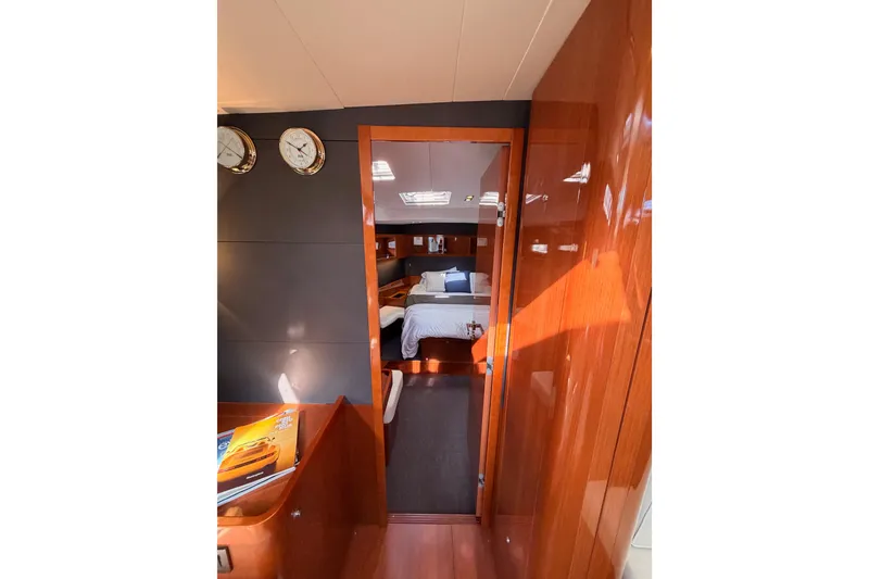 Slide: The Image of Luxurious interior of 2015 Beneteau Oceanis Yacht 60, featuring elegant wood finishes and cozy cabin. - 80