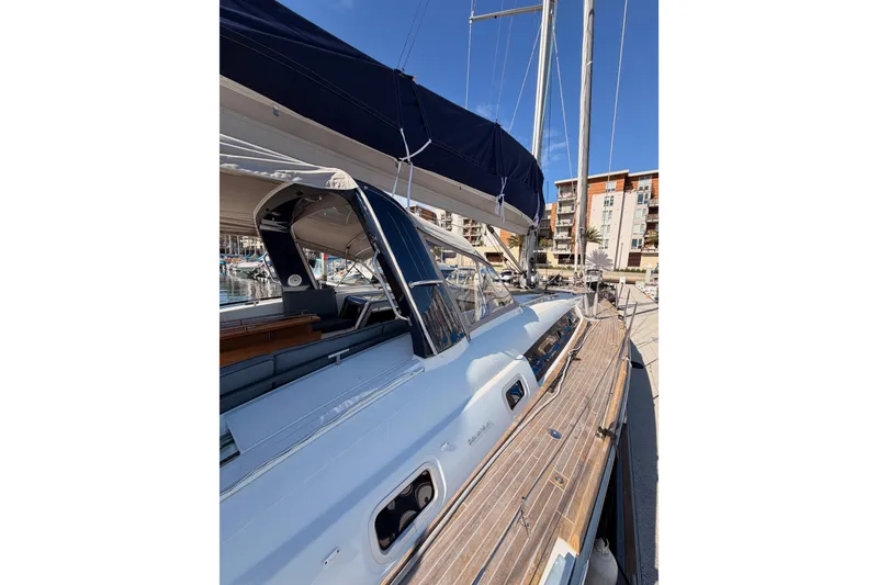 Slide: The Image of Beneteau Oceanis Yacht 60, 2015 model, docked with sleek design and wooden deck. - 9