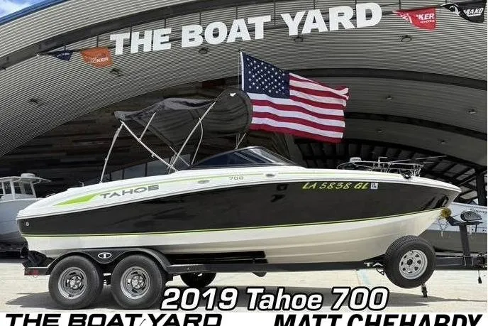 The Image of 2019 Tahoe 700 boat on trailer at The Boat Yard with American flag. - 0