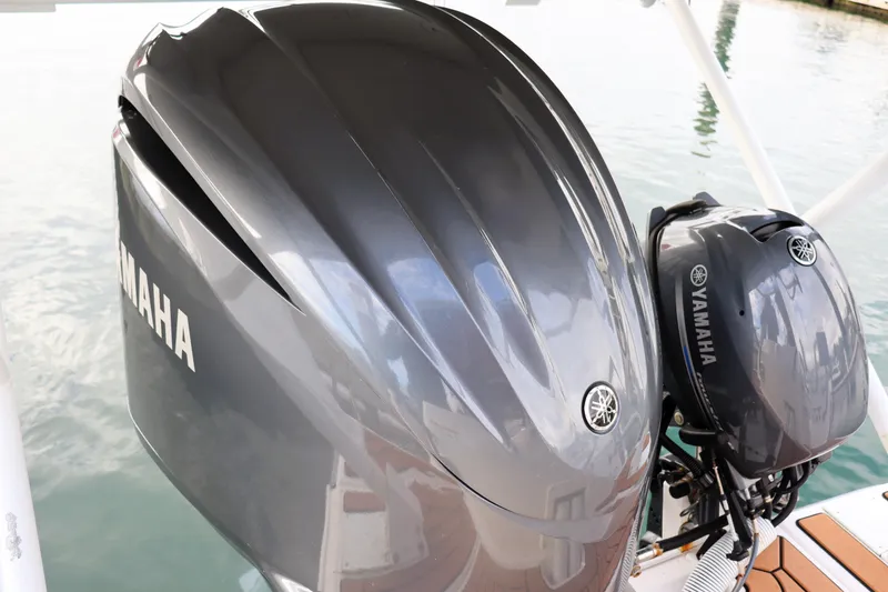 Slide: The Image of Yamaha outboard engines on a 2021 Ranger Tugs R-27 boat, docked by the water. - 10