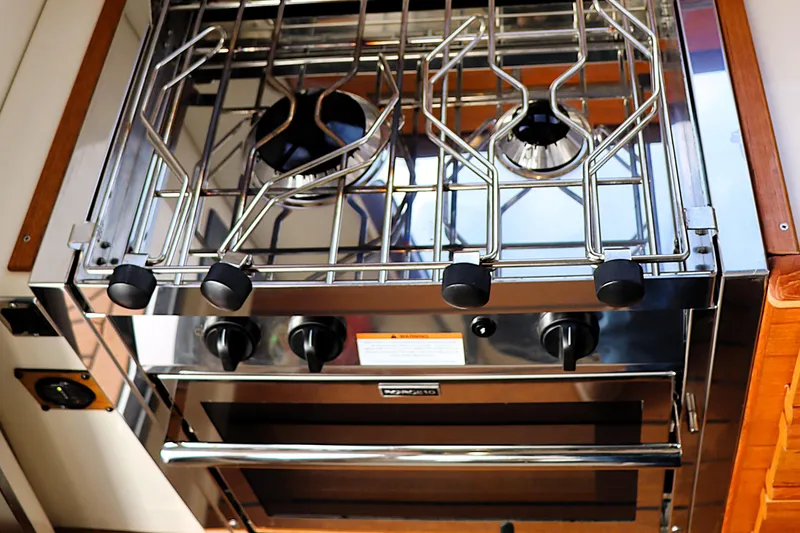 Slide: The Image of Stainless steel stove and oven in 2021 Ranger Tugs R-27 boat kitchen. - 23