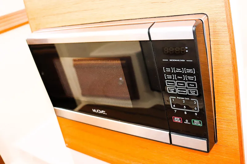 Slide: The Image of Microwave oven in 2021 Ranger Tugs R-27 boat interior, featuring digital controls. - 24