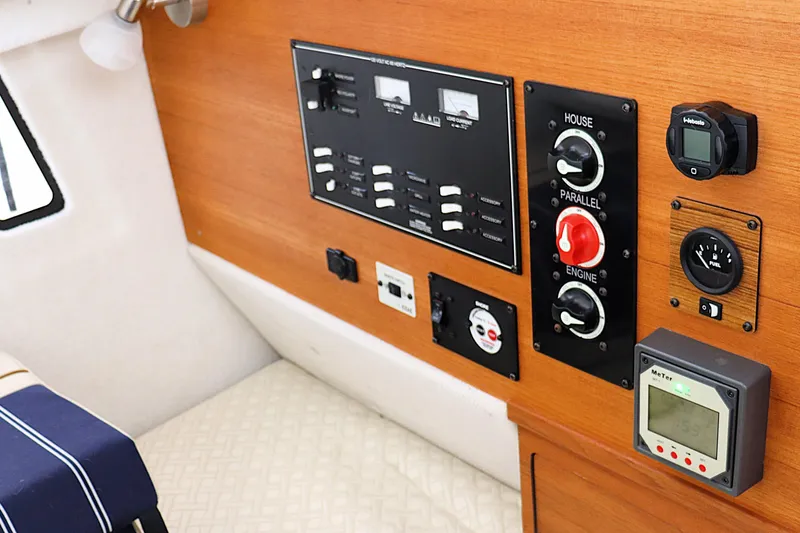 Slide: The Image of Control panel of 2021 Ranger Tugs R-27 boat with switches and gauges. - 26