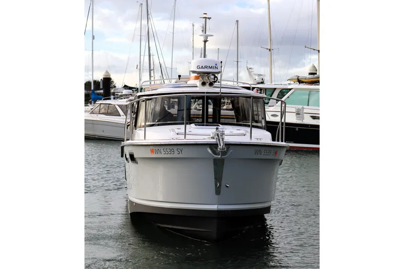 Slide: The Image of 2021 Ranger Tugs R-27 boat docked in marina, front view with Garmin equipment. - 9