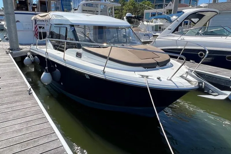 Slide: The Image of 2017 Jeanneau Merry Fisher 795 docked at marina, side view. - 1