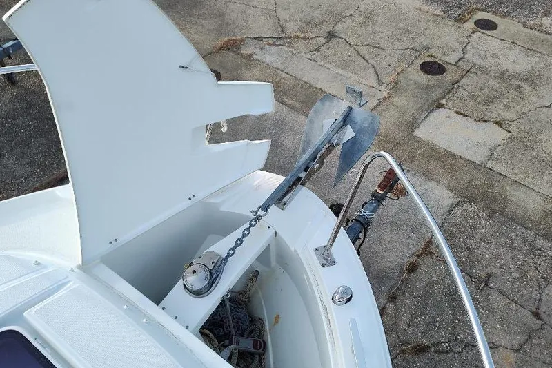 Slide: The Image of 2017 Jeanneau Merry Fisher 795 anchor compartment with open hatch and visible anchor chain. - 13