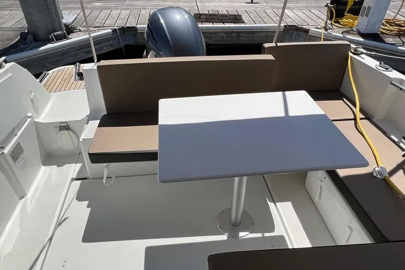 Slide: The Image of 2017 Jeanneau Merry Fisher 795 boat interior with seating and table. - 18