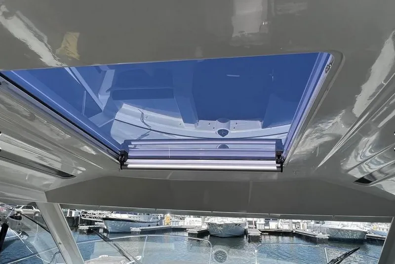 Slide: The Image of 2017 Jeanneau Merry Fisher 795 boat interior with open sunroof, docked at marina. - 20