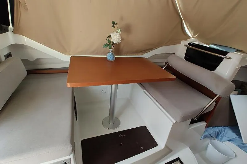 Slide: The Image of Interior of 2017 Jeanneau Merry Fisher 795 with table and seating area. - 22