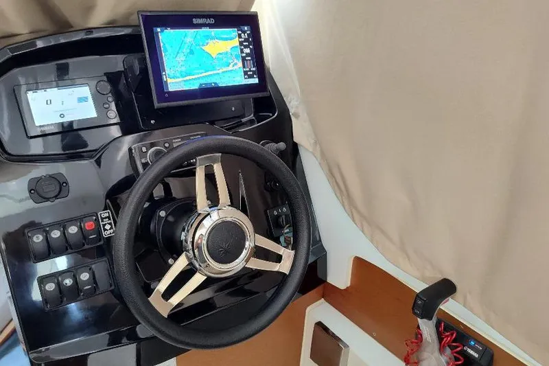 Slide: The Image of Steering console of 2017 Jeanneau Merry Fisher 795 with navigation display. - 24