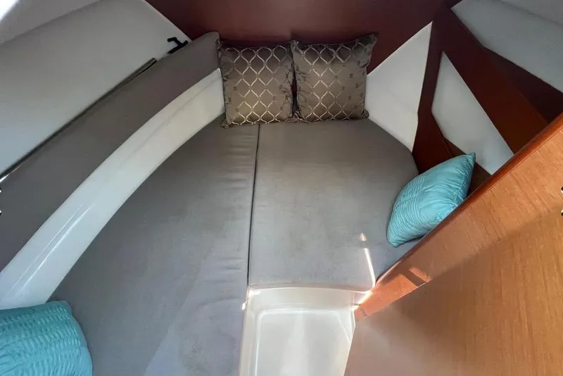Slide: The Image of Cozy cabin interior of 2017 Jeanneau Merry Fisher 795 with cushions and wooden accents. - 28