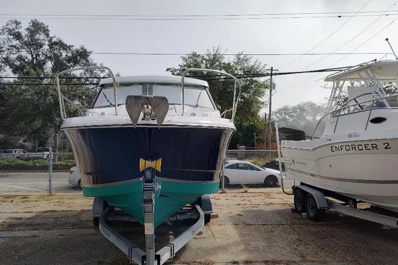 Slide: The Image of 2017 Jeanneau Merry Fisher 795 boat on trailer, parked beside another boat. - 5