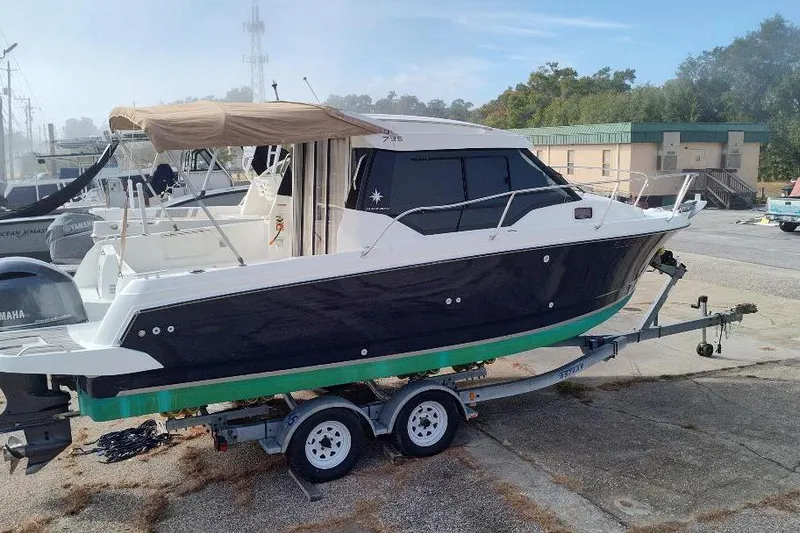 Slide: The Image of 2017 Jeanneau Merry Fisher 795 boat on trailer, parked outdoors. - 6