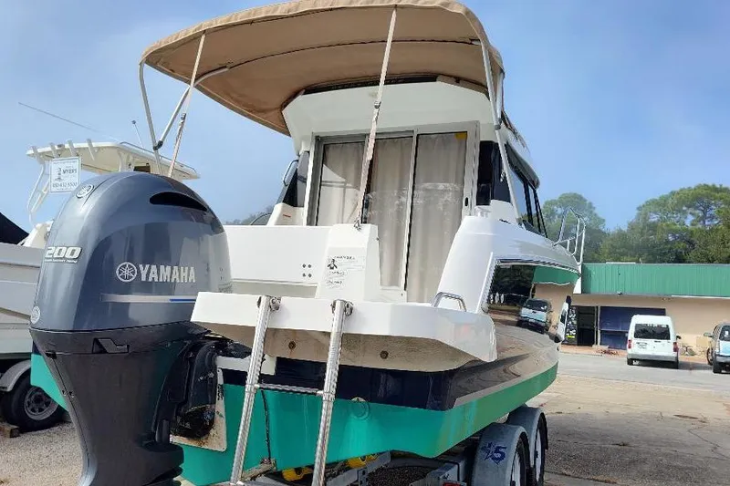 Slide: The Image of 2017 Jeanneau Merry Fisher 795 boat with Yamaha 200 engine, parked on trailer. - 9
