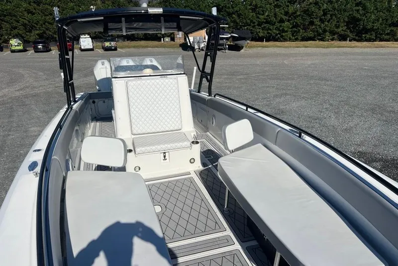 Slide: The Image of 2006 Dakota 36 Open boat interior with seating and helm, parked outdoors. - 13
