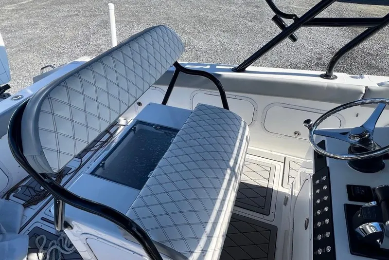 Slide: The Image of 2006 Dakota 36 Open boat interior with diamond-stitched seating and steering console. - 15