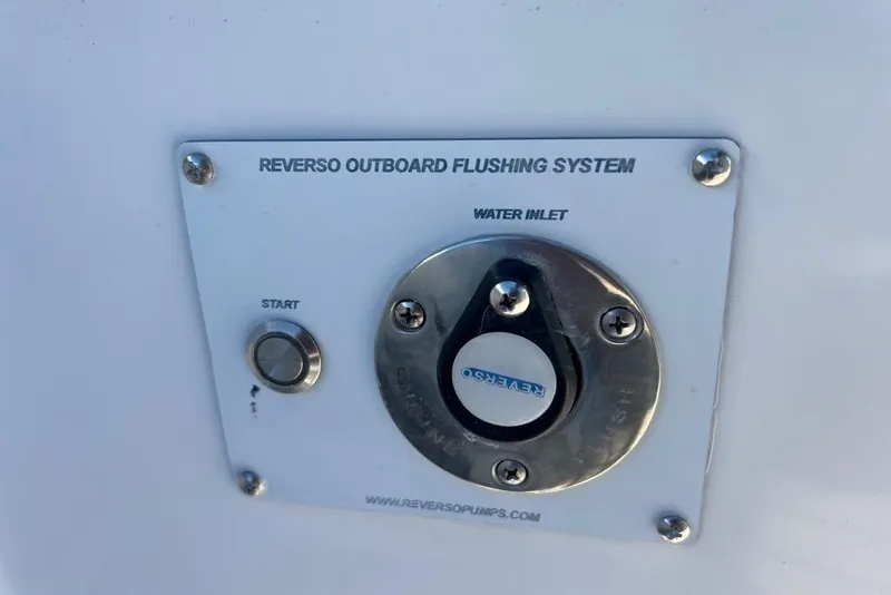 Slide: The Image of Reverso outboard flushing system on 2006 Dakota 36 Open boat, featuring water inlet and start button. - 16