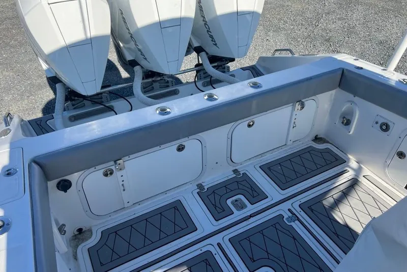 Slide: The Image of 2006 Dakota 36 Open boat with triple Mercury outboard engines and spacious deck layout. - 18