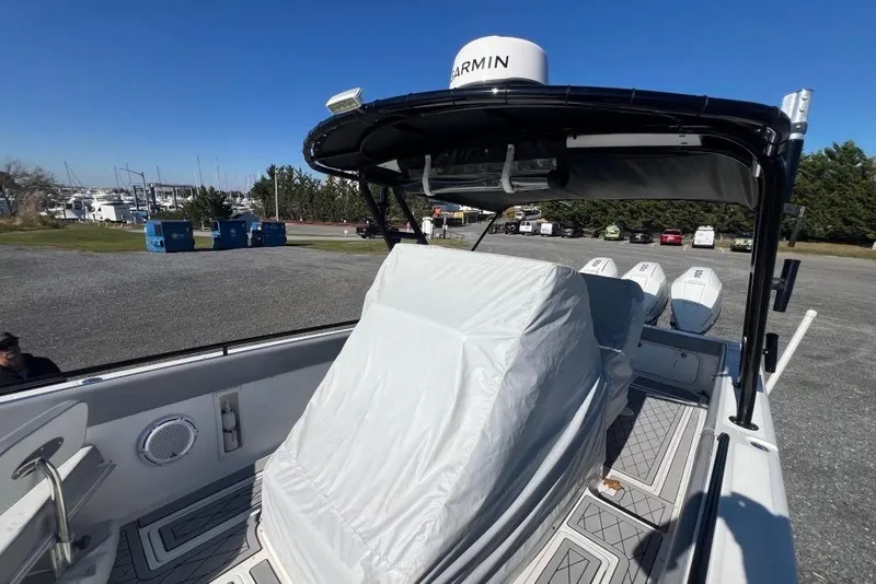Slide: The Image of 2006 Dakota 36 Open boat with covered seating and Garmin equipment, docked outdoors. - 22