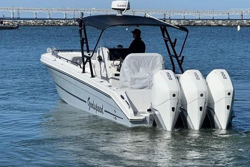 Slide: The Image of 2006 Dakota 36 Open boat with triple engines on calm water. - 4