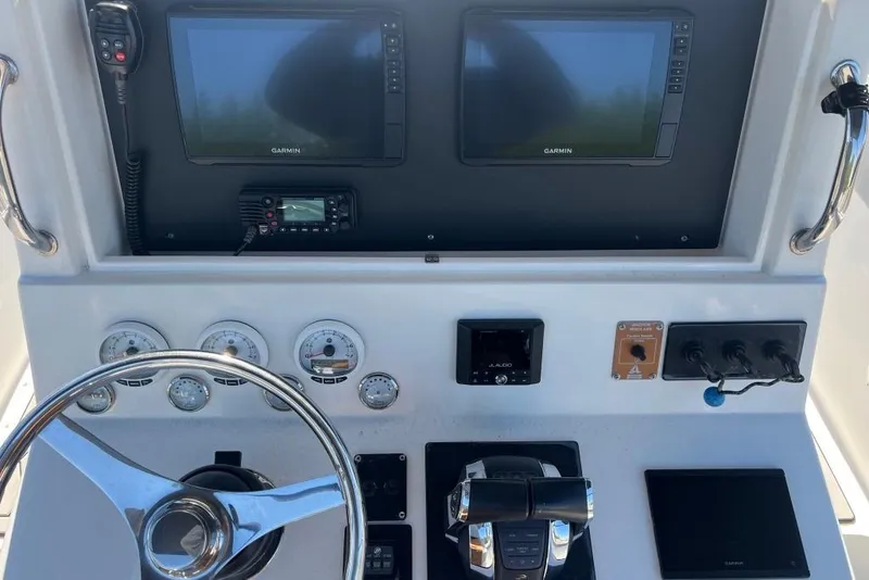 Slide: The Image of Control panel of a 2006 Dakota 36 Open boat with Garmin displays and steering wheel. - 7