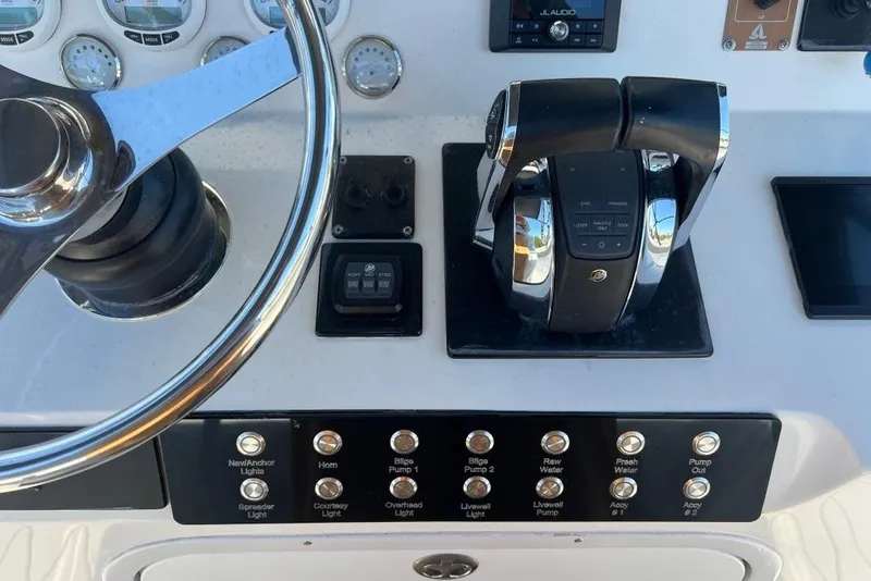 Slide: The Image of Control panel of a 2006 Dakota 36 Open boat with steering wheel and throttle. - 8