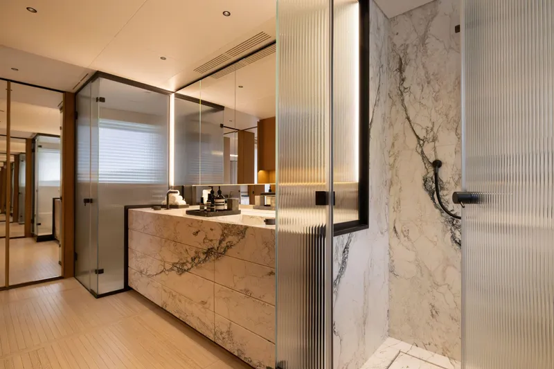 Slide: The Image of Luxurious bathroom in 2024 Benetti Oasis 34M yacht, featuring marble and glass design elements. - 28