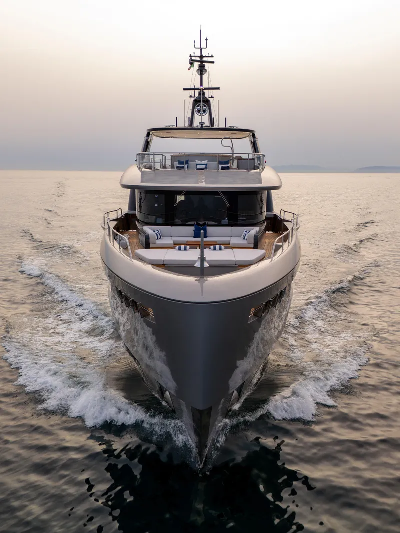 Slide: The Image of 2024 Benetti Oasis 34M yacht cruising on open water at sunset. - 3