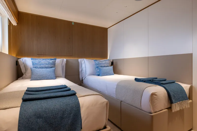 Slide: The Image of Luxurious twin bedroom on 2024 Benetti Oasis 34M yacht, featuring elegant decor and cozy bedding. - 37