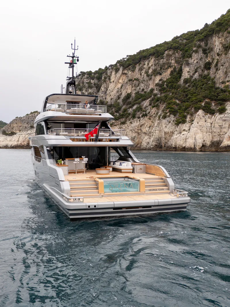 Slide: The Image of 2024 Benetti Oasis 34M yacht with luxurious deck and scenic coastal backdrop. - 8