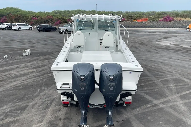 Slide: The Image of 2026 Steiger Craft 28 Hawaii boat with dual Yamaha engines in a parking lot. - 10