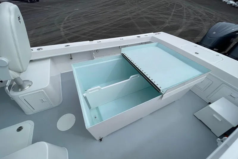 Slide: The Image of 2026 Steiger Craft 28 Hawaii boat deck with open storage compartment and seating. - 12