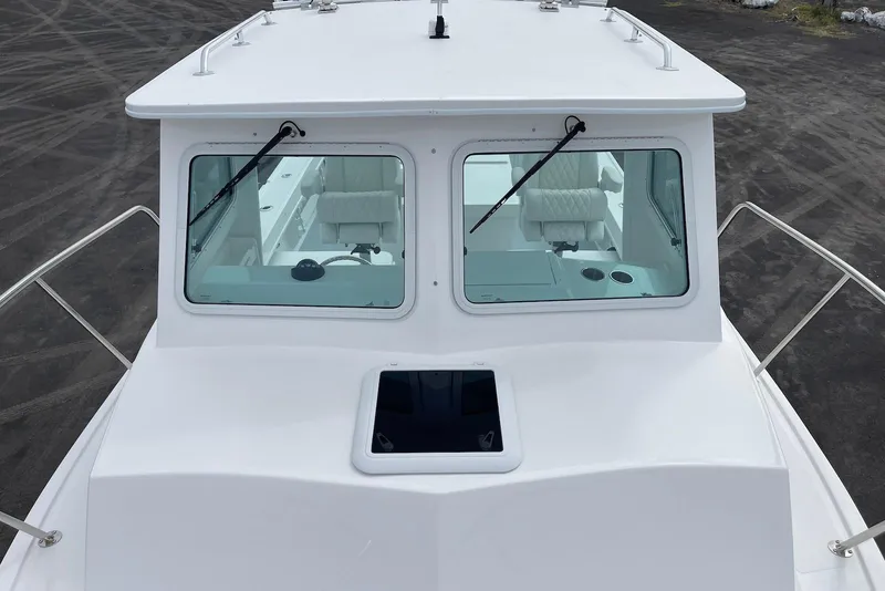 Slide: The Image of 2026 Steiger Craft 28 Hawaii boat, front view with windshield and deck details. - 13