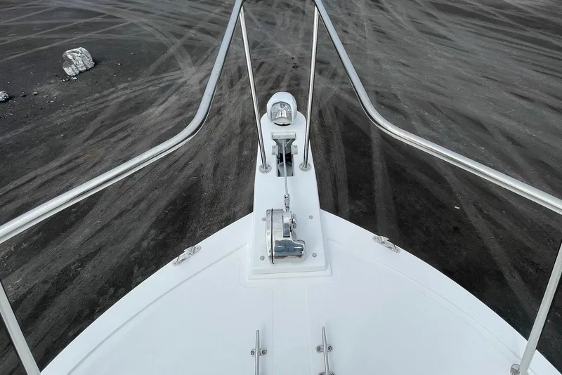 Slide: The Image of Bow view of 2026 Steiger Craft 28 Hawaii boat on dark textured surface. - 14