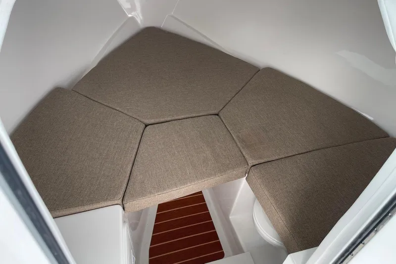 Slide: The Image of 2026 Steiger Craft 28 Hawaii cabin interior with cushioned seating and wooden flooring. - 15