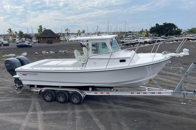 Slide: The Image of 2026 Steiger Craft 28 Hawaii boat on trailer, parked near marina. - 6