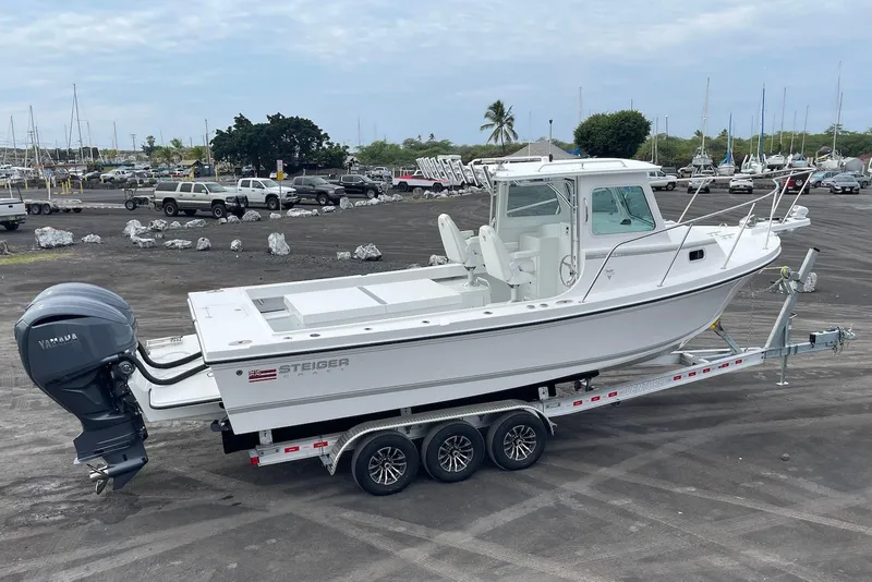 Slide: The Image of 2026 Steiger Craft 28 Hawaii boat on trailer, parked in marina lot. - 7