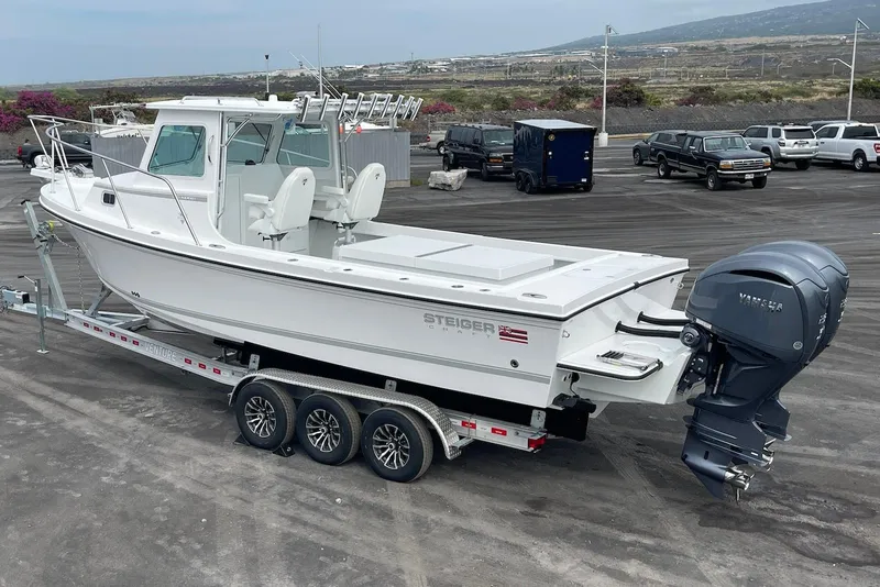 Slide: The Image of 2026 Steiger Craft 28 Hawaii boat on trailer, featuring a powerful outboard motor. - 9