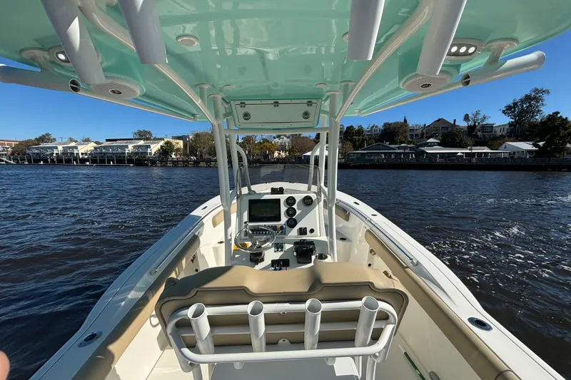 Slide: The Image of 2019 Key West 244 Center Console boat on water, featuring helm and seating area. - 12