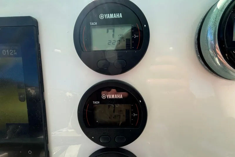 Slide: The Image of Yamaha tachometers on 2019 Key West 244 Center Console boat dashboard. - 14