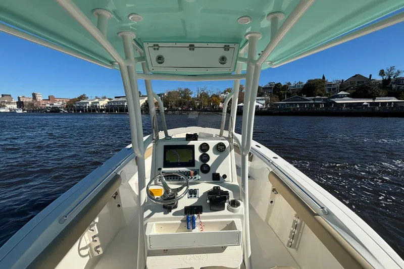 Slide: The Image of 2019 Key West 244 Center Console boat on water, featuring helm and controls. - 15