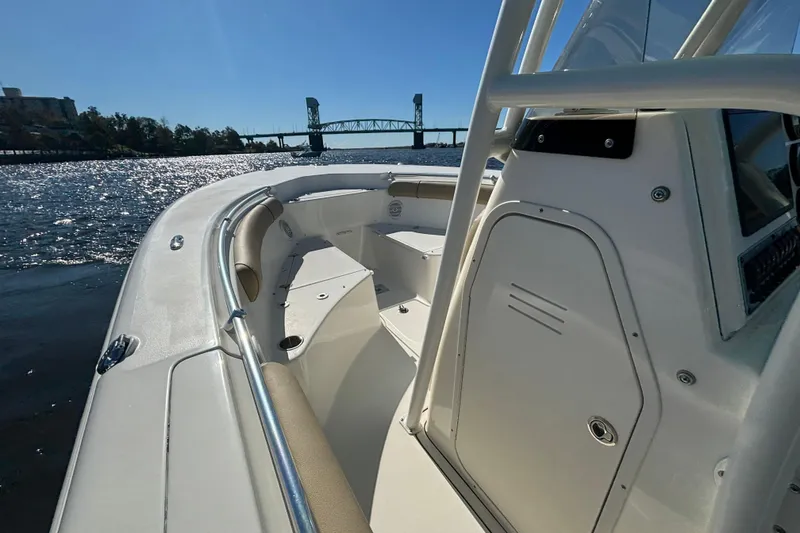 Slide: The Image of 2019 Key West 244 Center Console boat on water near a bridge, sunny day. - 16