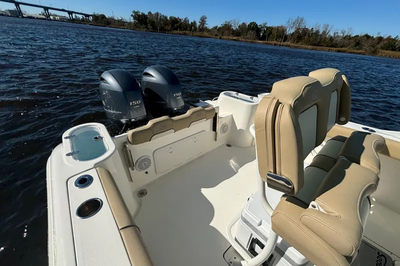Slide: The Image of 2019 Key West 244 Center Console boat with dual 150 horsepower engines on a sunny day. - 22