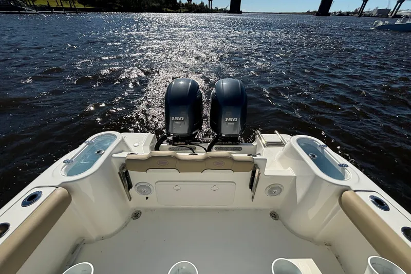 Slide: The Image of 2019 Key West 244 Center Console boat with dual 150 engines on a sunny day. - 23