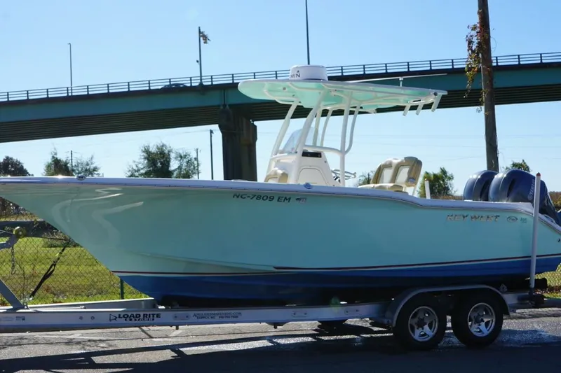 Slide: The Image of 2019 Key West 244 Center Console boat on trailer under a bridge. - 26