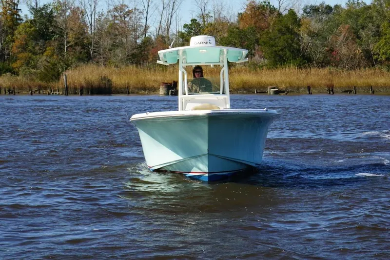Slide: The Image of 2019 Key West 244 Center Console boat navigating a calm river with autumn trees. - 3