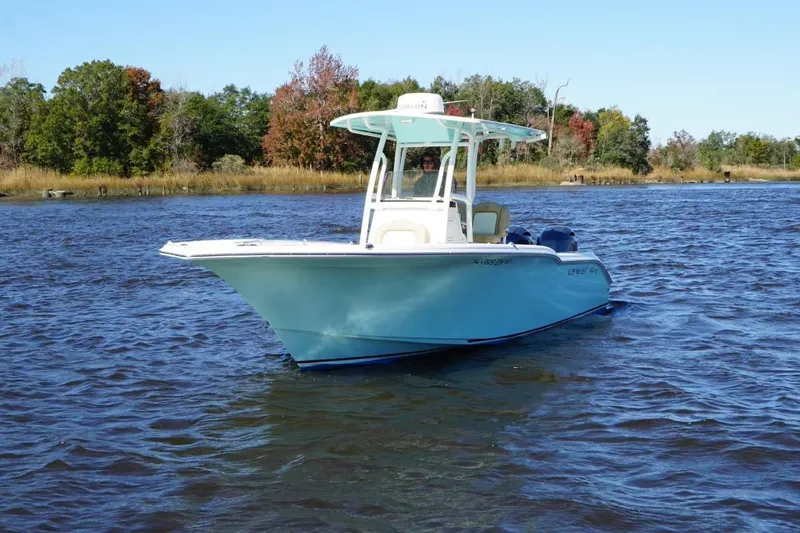 Slide: The Image of 2019 Key West 244 Center Console boat on a calm lake with trees in the background. - 4