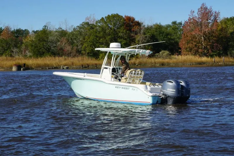 Slide: The Image of 2019 Key West 244 Center Console boat cruising on a scenic river. - 6