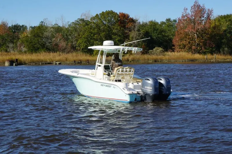 Slide: The Image of 2019 Key West 244 Center Console boat on a scenic river with autumn trees. - 7