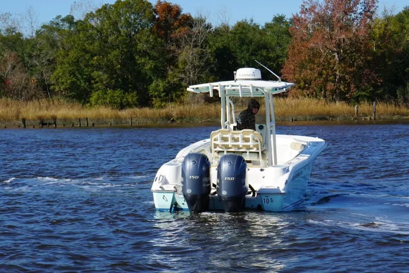 Slide: The Image of 2019 Key West 244 Center Console boat cruising on a scenic river. - 9